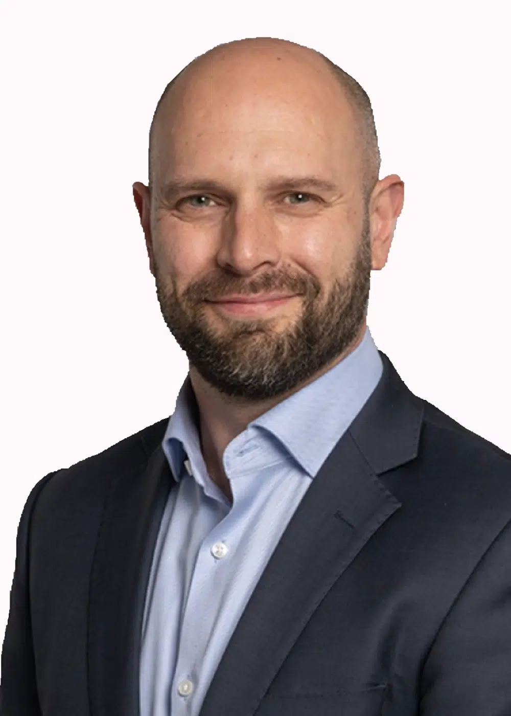 Harry Dronfiled - Colman Coyle Professional headshot of a smiling bald man with a beard, wearing a navy suit and light blue shirt.